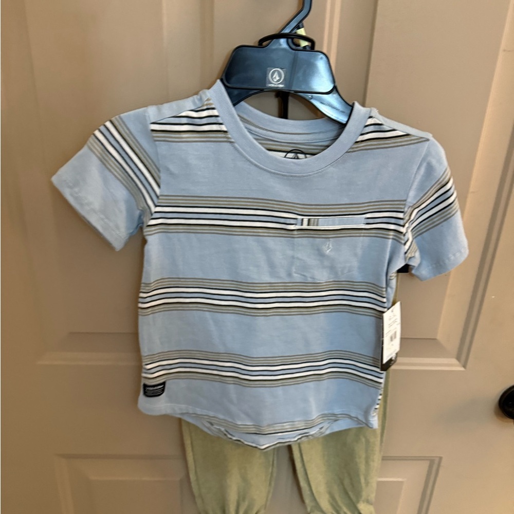 Volcom Light Blue Striped Kids Tee with tan pants.